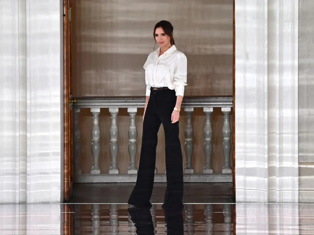 Victoria Beckham white blouse and black pantalon outfit 2025