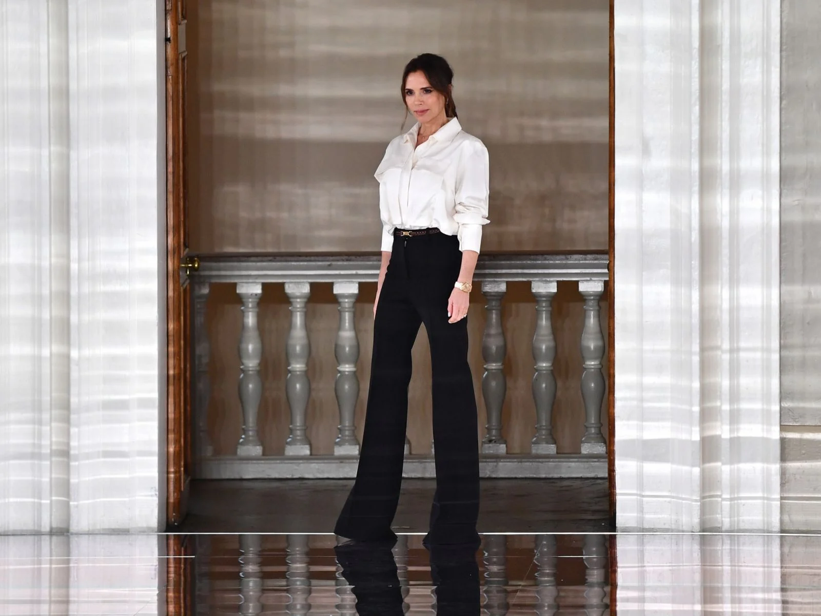 Victoria Beckham white blouse and black pantalon outfit 2025